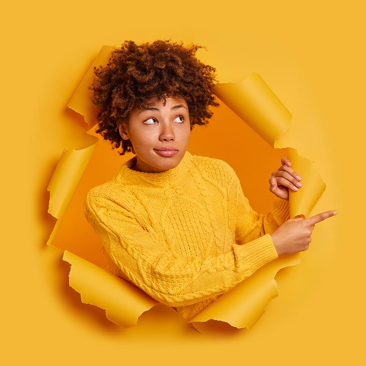 serious-thoughtful-dark-skinned-millennial-girl-with-afro-bushy-hair-points-away-copy-space